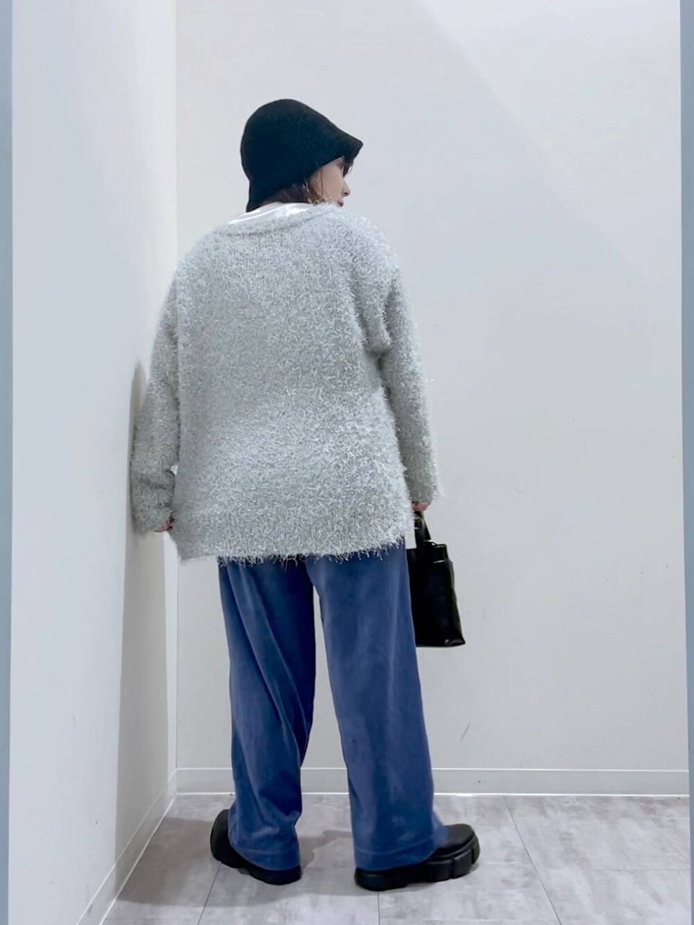 ブラック系のブーツ、ブラック系のショルダーバッグ、グレー系のカーディガン/ボレロを着用したレディースの冬コーディネートの3枚目の写真