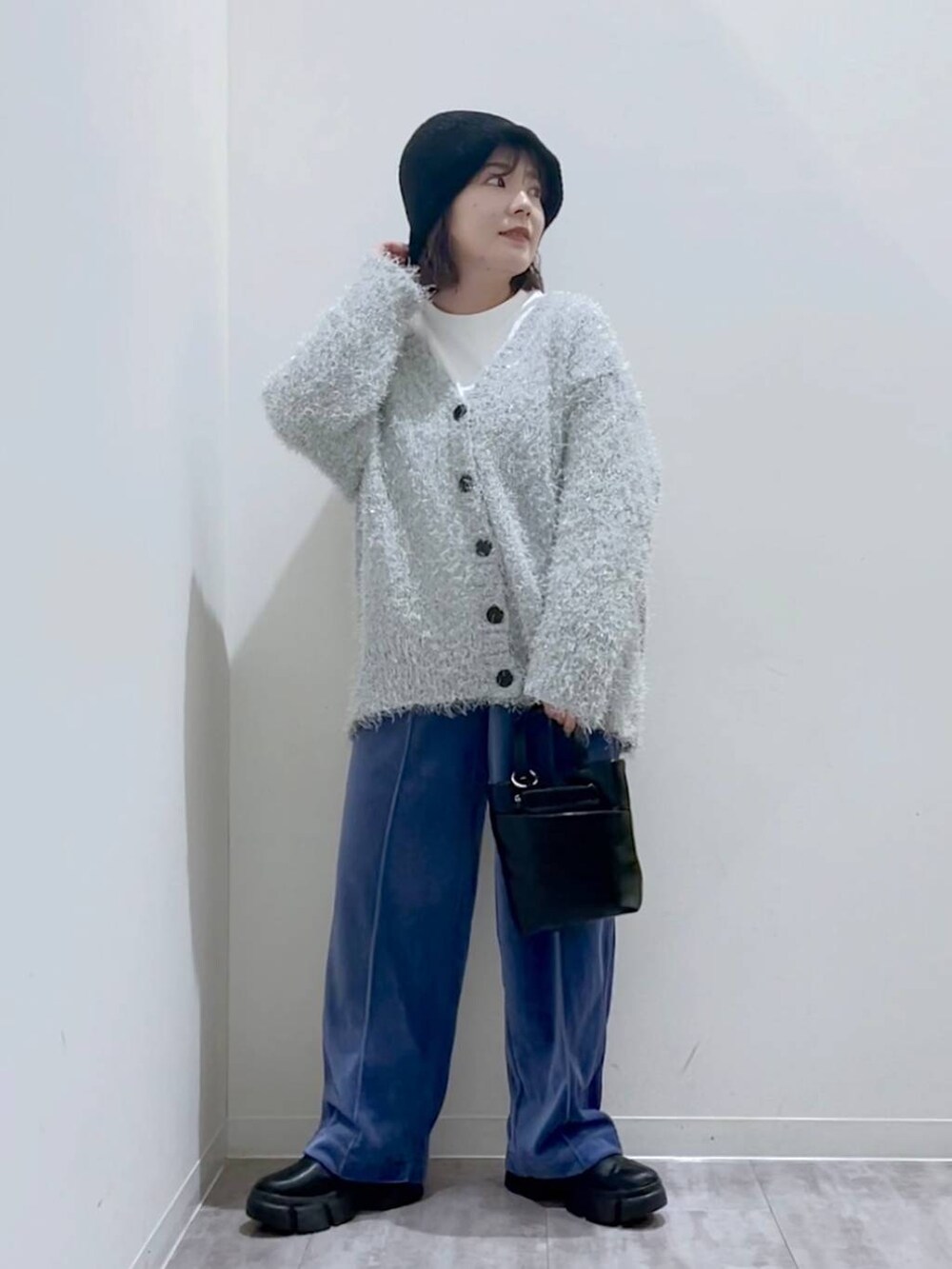 ブラック系のブーツ、ブラック系のショルダーバッグ、グレー系のカーディガン/ボレロを着用したレディースの冬コーディネートの5枚目の写真