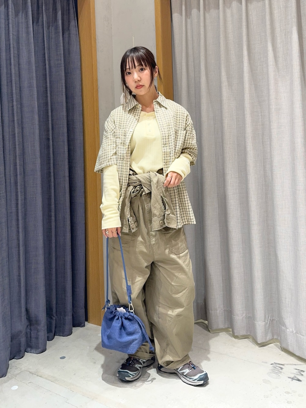 イエロー系のTシャツ/カットソー、ベージュ系のサロペット/オーバーオール、ベージュ系のシャツ/ブラウスを着用したレディースの春コーディネートの2枚目の写真