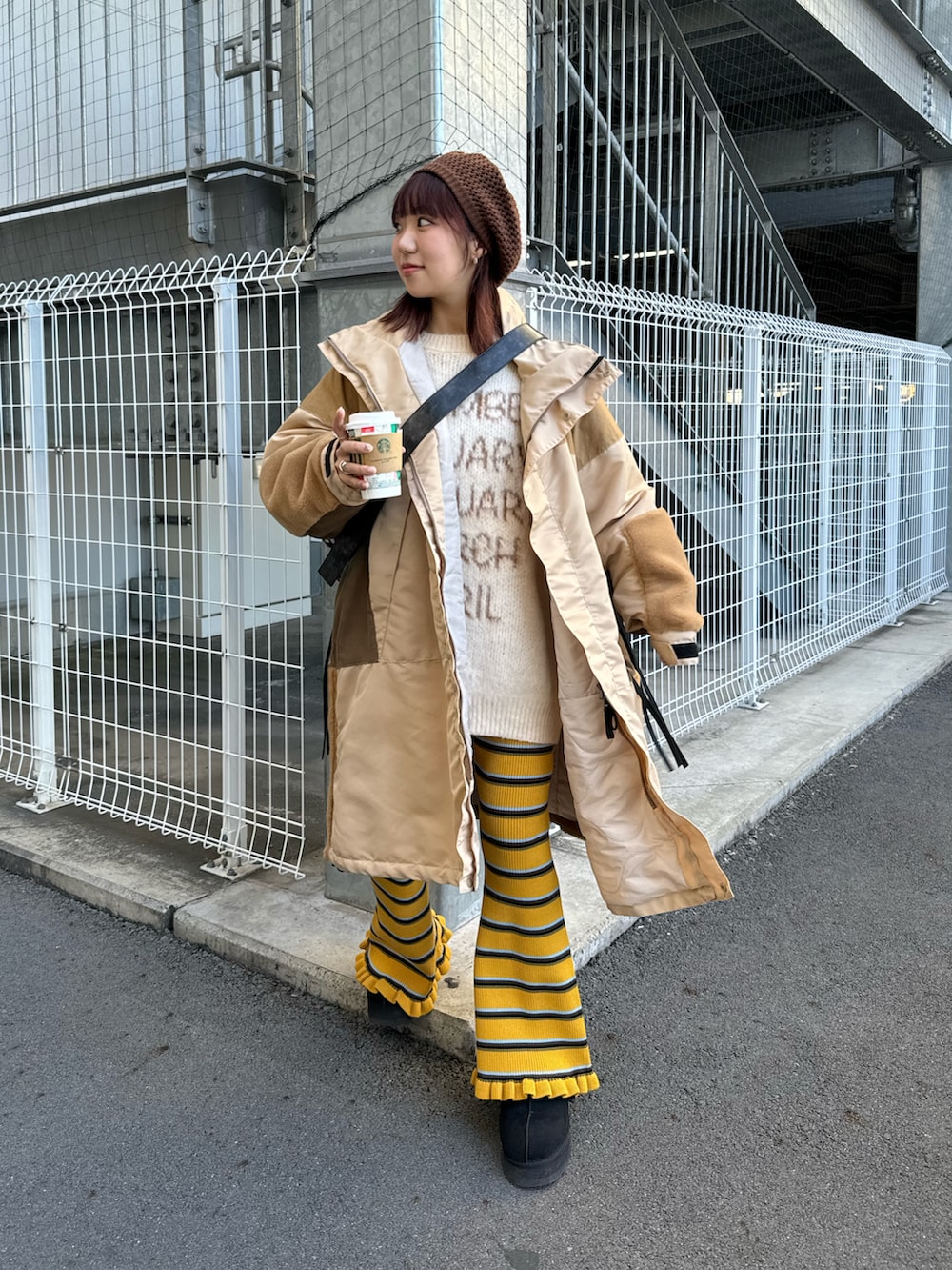 ベージュ系のニット/セーター、イエロー系のパンツ、イエロー系のダウンジャケット/コートを着用したレディースの冬コーディネートの3枚目の写真