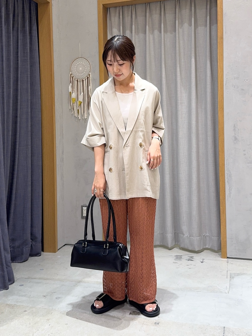ベージュ系のテーラードジャケット、イエロー系のその他パンツ、ブラック系のトートバッグを着用したレディースの夏コーディネートの2枚目の写真