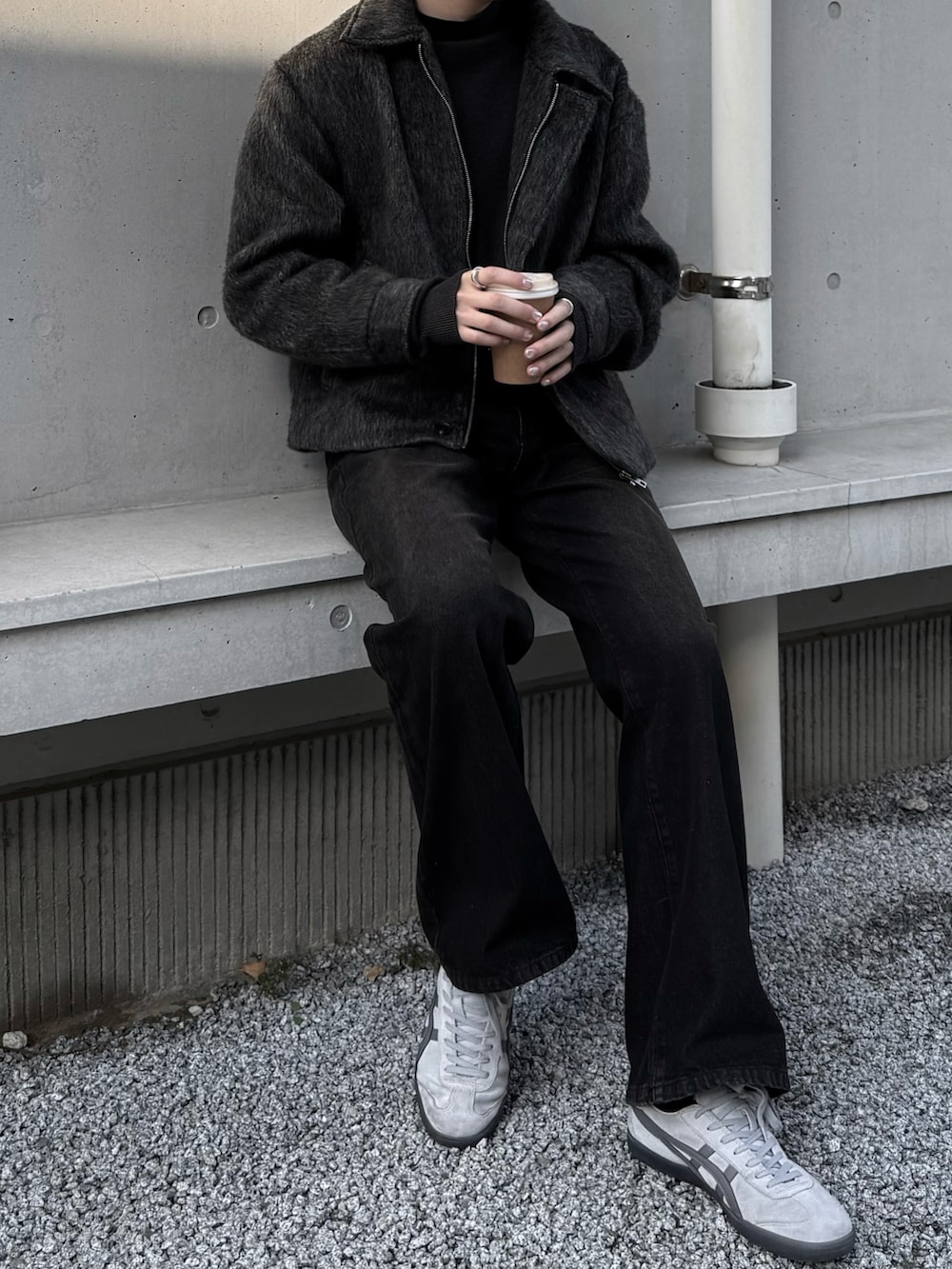 ブラウン系のデニムパンツ、グレー系のスニーカーを着用したメンズの冬コーディネートの2枚目の写真