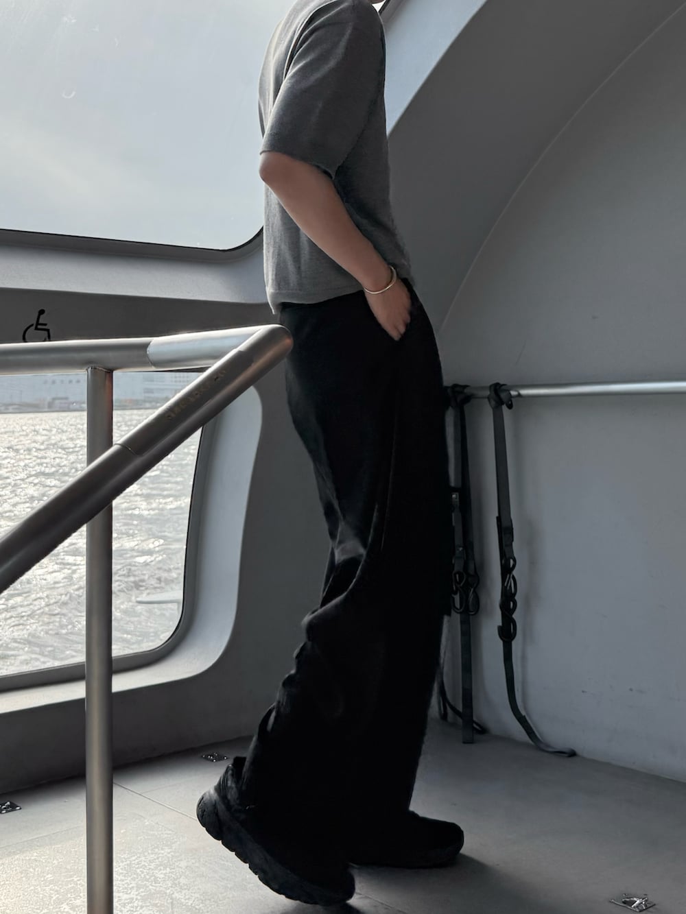 ブラック系のスニーカー、ブラック系のスラックス、グレー系のTシャツ/カットソーを着用したメンズの夏コーディネートの2枚目の写真