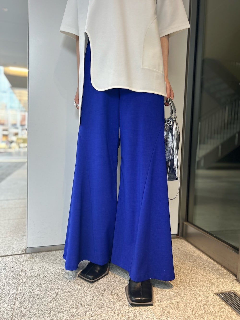 ホワイト系のTシャツ/カットソー、ブラック系のパンプス、ブルー系のその他パンツを着用したレディースの冬コーディネートの6枚目の写真