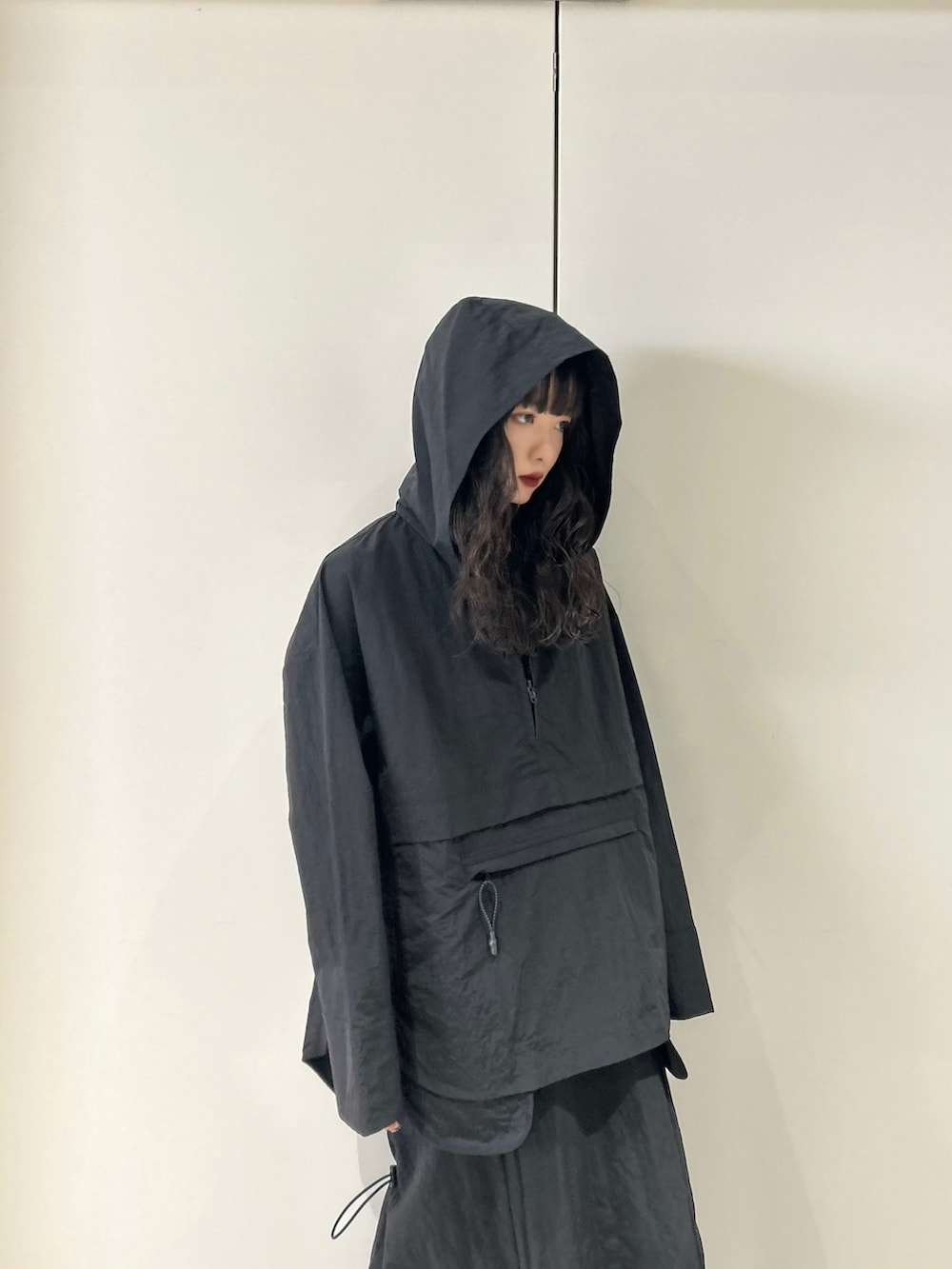 ブラック系のマウンテンパーカー、ブラック系のスカート、その他のサンダルを着用したレディースの春コーディネートの2枚目の写真