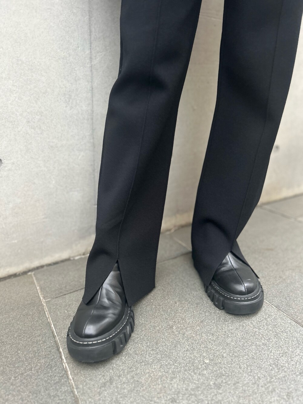 パープル系のニット/セーター、ブラック系のその他パンツ、ブラック系のブーツを着用したレディースの秋コーディネートの7枚目の写真