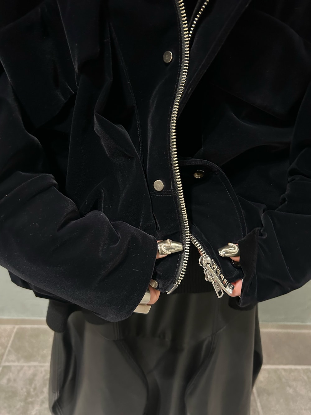 ブラック系のその他アウター、ブラック系のニット/セーター、ブラック系のスカートを着用したレディースの秋コーディネートの9枚目の写真