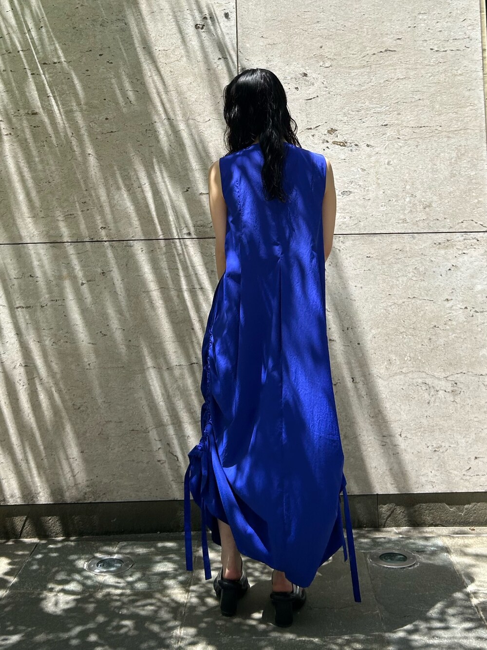 ブルー系のワンピース、シルバー系のサンダル、ベージュ系のハットを着用したレディースの春コーディネートの4枚目の写真