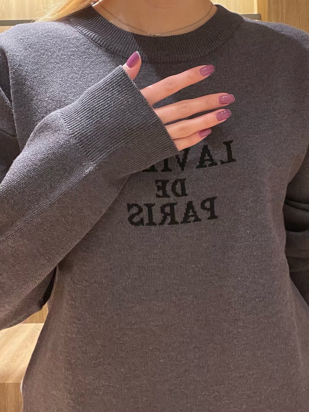 ブラック系のスカート、ブラック系のブーツ、グレー系のハンドバッグを着用したレディースの冬コーディネートの7枚目の写真