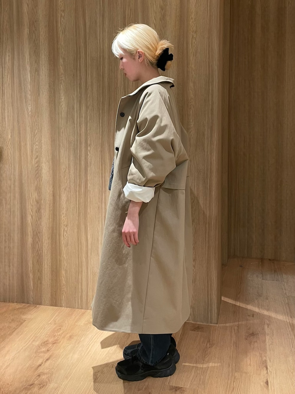 ブラック系のスニーカー、ブルー系のデニムパンツ、ブラック系のボストンバッグを着用したレディースの冬コーディネートの2枚目の写真