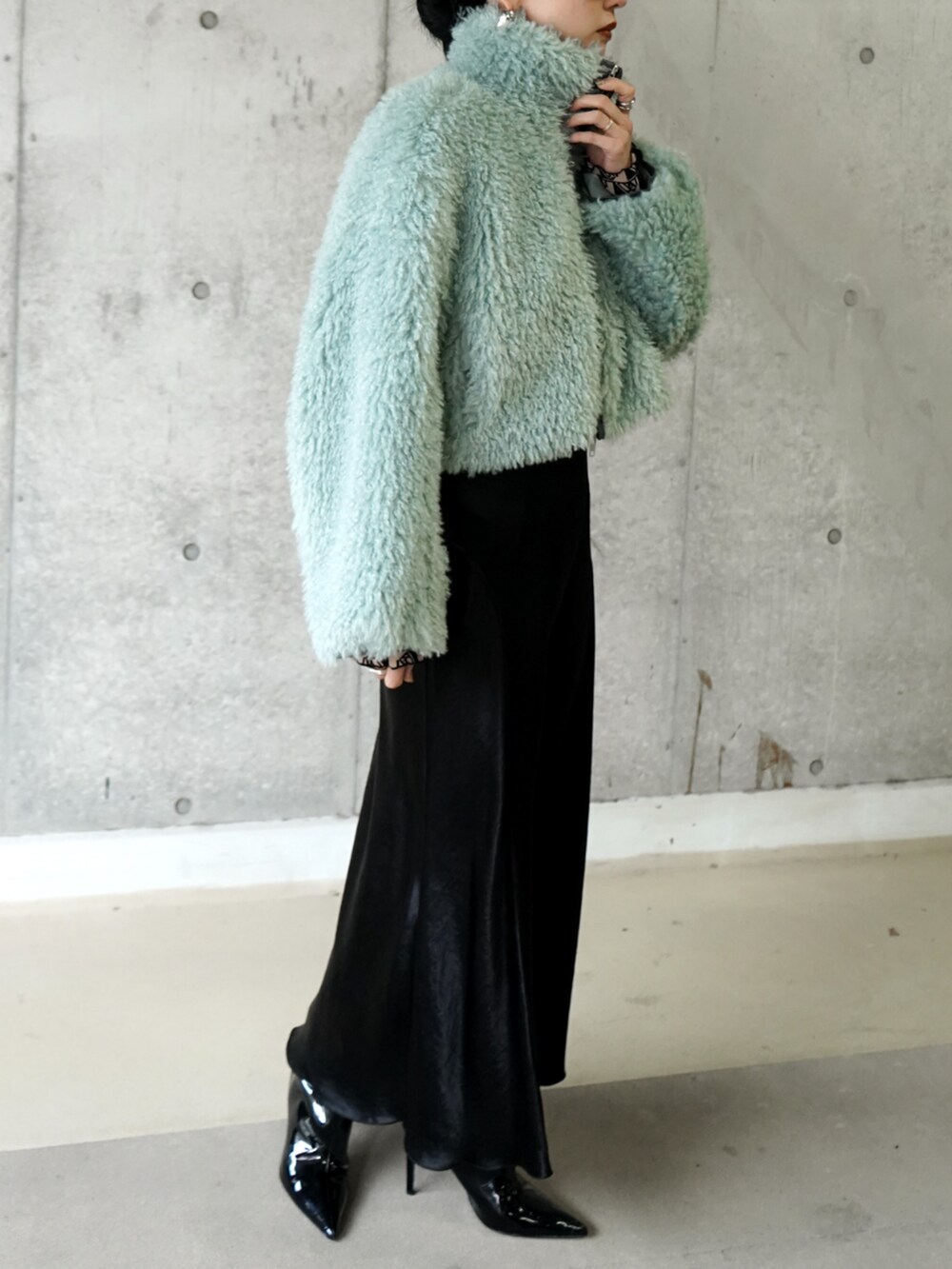 グリーン系のブルゾンを着用したレディースの冬コーディネートの3枚目の写真