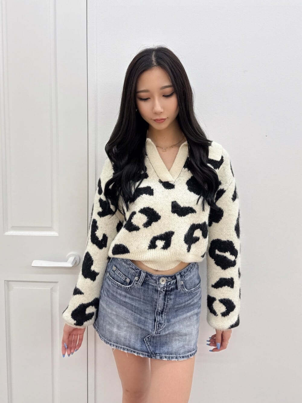 ブルー系のデニムスカート、その他のニット/セーター、ブラック系のブーツを着用したレディースの秋コーディネートの4枚目の写真