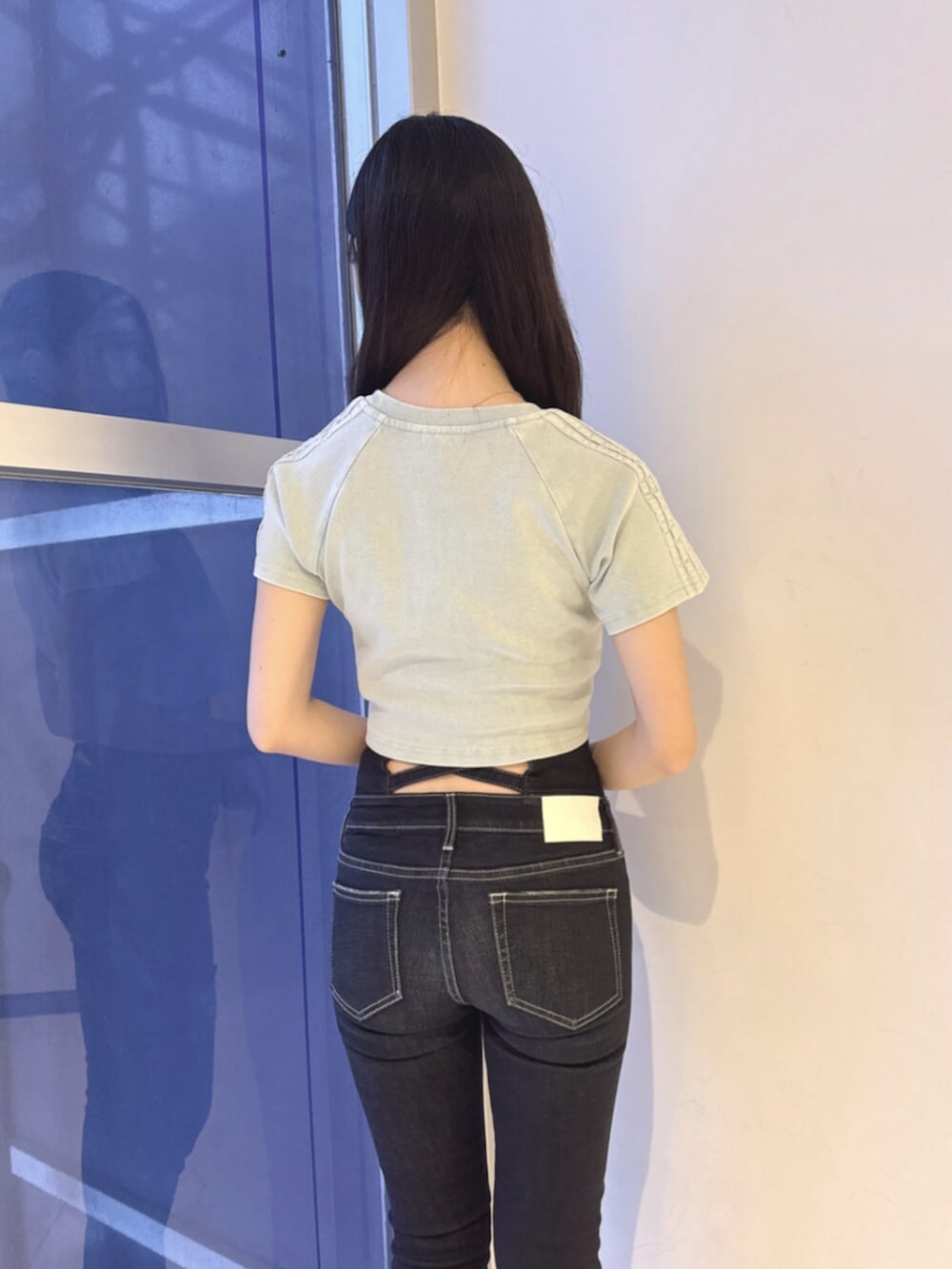 ブルー系のデニムパンツ、ブラック系のサンダル、ブルー系のTシャツ/カットソーを着用したレディースの夏コーディネートの5枚目の写真