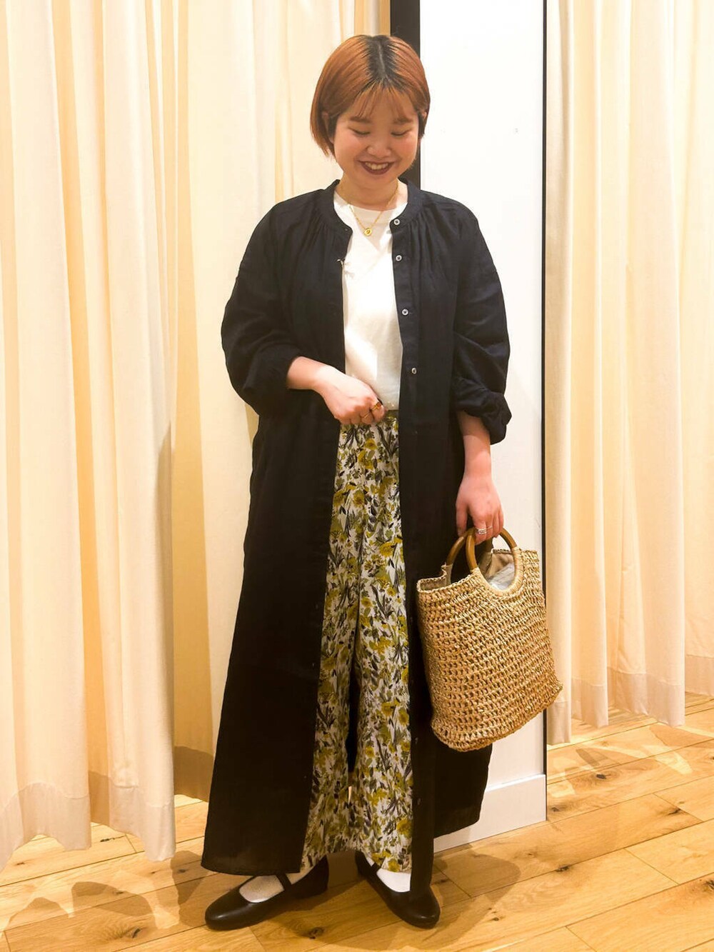 ブルー系のワンピース、ブラック系のパンプス、ベージュ系のトートバッグを着用したレディースの春コーディネートの3枚目の写真