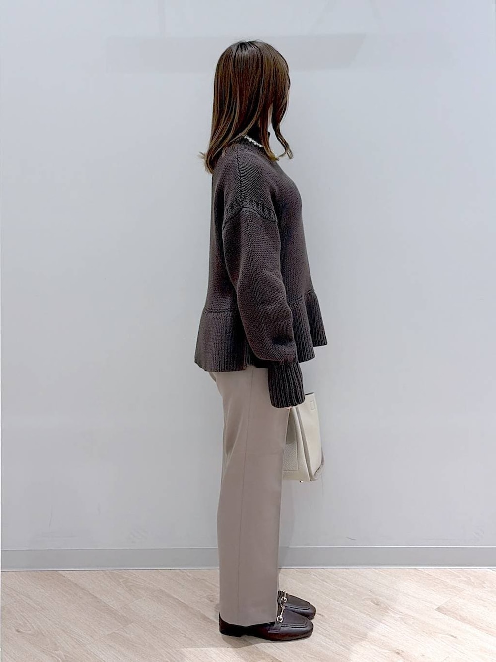 ブラウン系のローファー、ブラウン系のその他パンツ、ベージュ系のトートバッグを着用したレディースの冬コーディネートの3枚目の写真