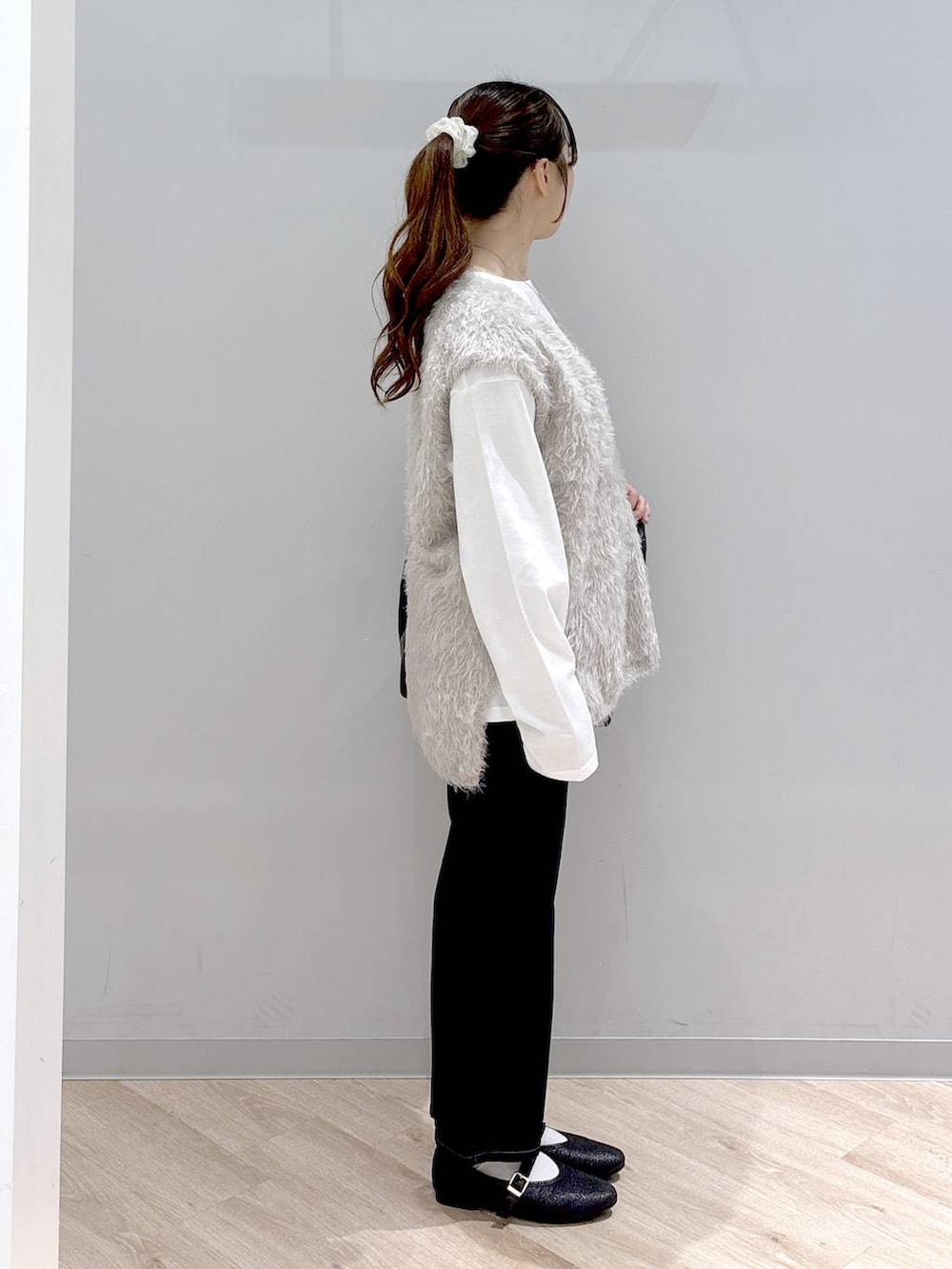 その他のパンプス、ブルー系のデニムパンツ、ベージュ系のベストを着用したレディースの秋コーディネートの3枚目の写真