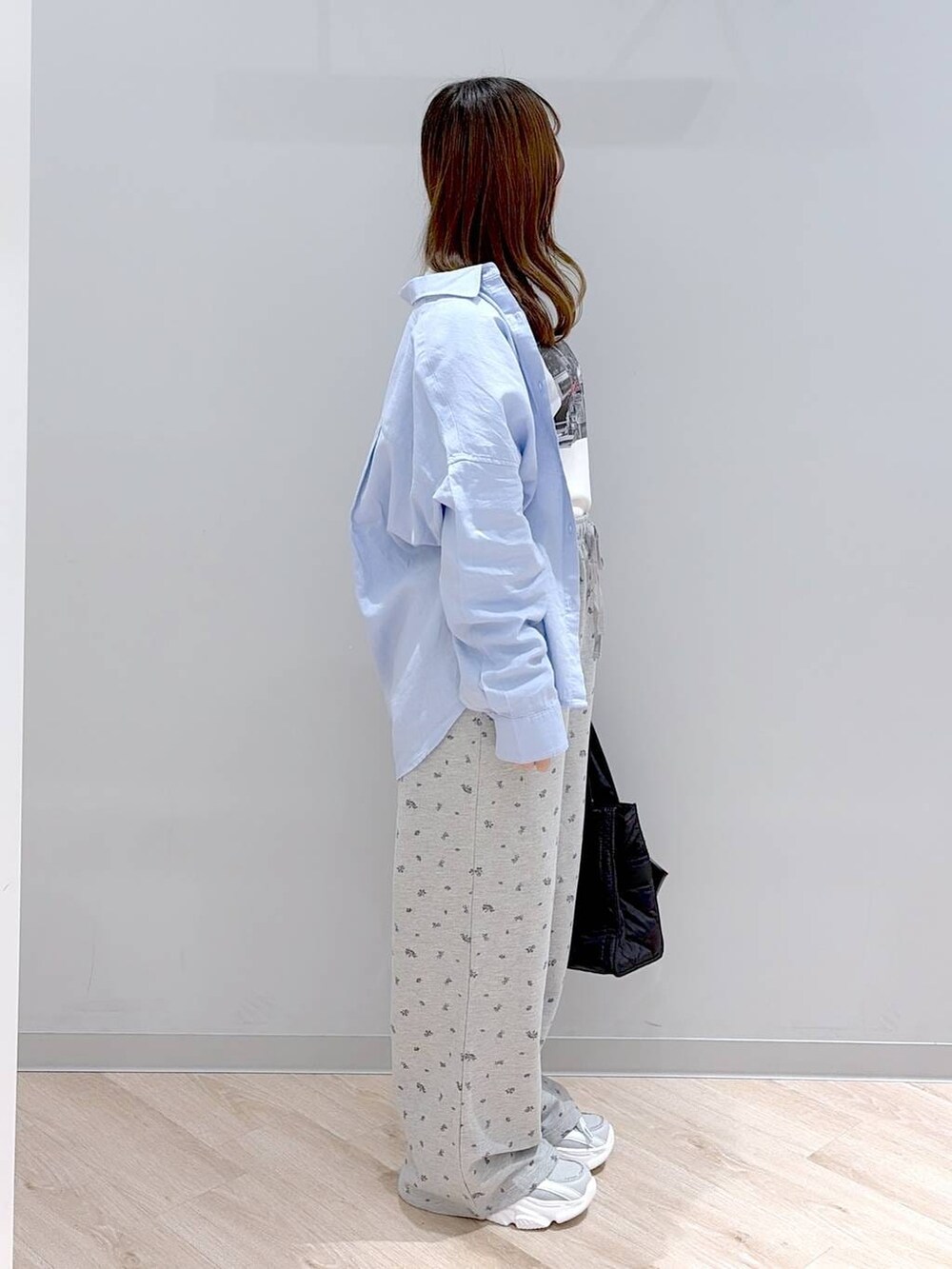 ブラック系のトートバッグ、ブルー系のシャツ/ブラウス、ホワイト系のTシャツ/カットソーを着用したレディースの春コーディネートの4枚目の写真