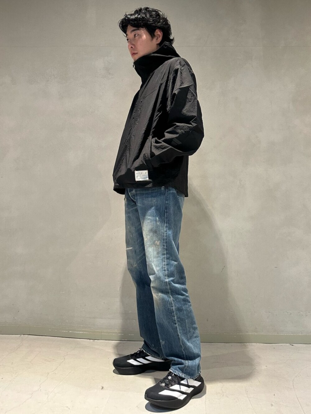 ブラック系のその他アウター、ブラック系のスニーカーを着用したメンズの冬コーディネートの2枚目の写真