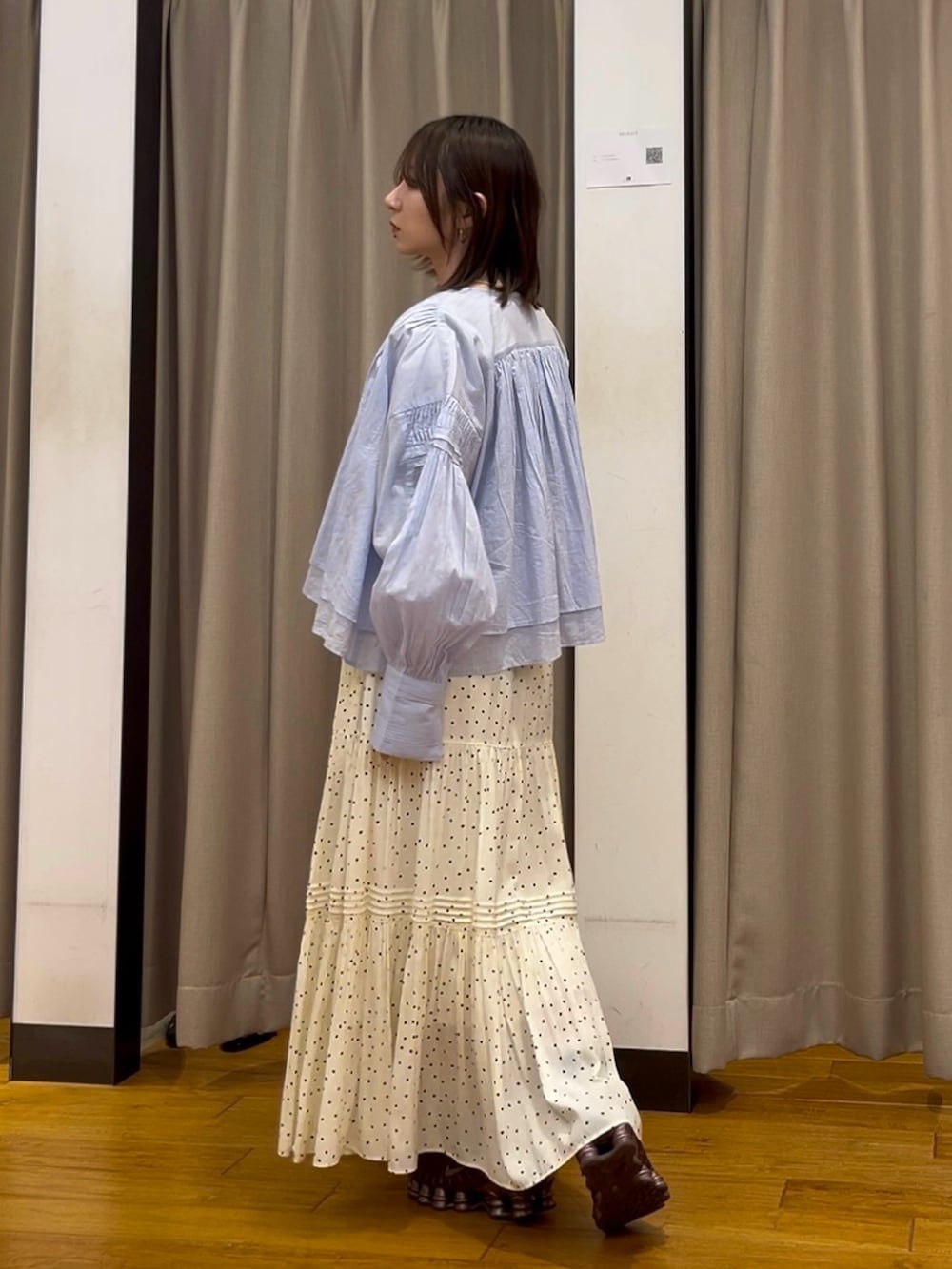 ホワイト系のスカート、ブルー系のシャツ/ブラウス、レッド系のスニーカーを着用したレディースの春コーディネートの2枚目の写真