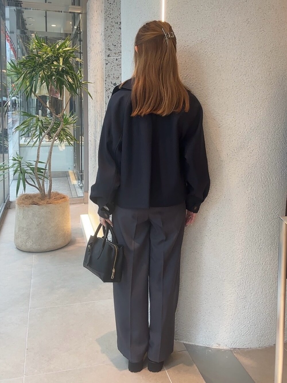 ブルー系のトレンチコート、ブルー系のシャツ/ブラウス、ブラック系のボストンバッグを着用したレディースの秋コーディネートの9枚目の写真