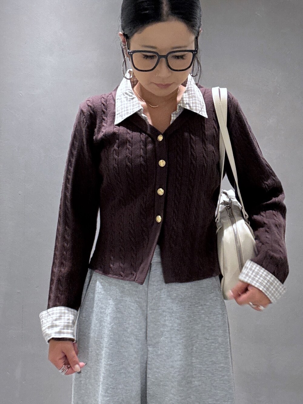 グレー系のその他パンツ、ベージュ系のスニーカー、ブラウン系のニット/セーターを着用したレディースの秋コーディネートの5枚目の写真