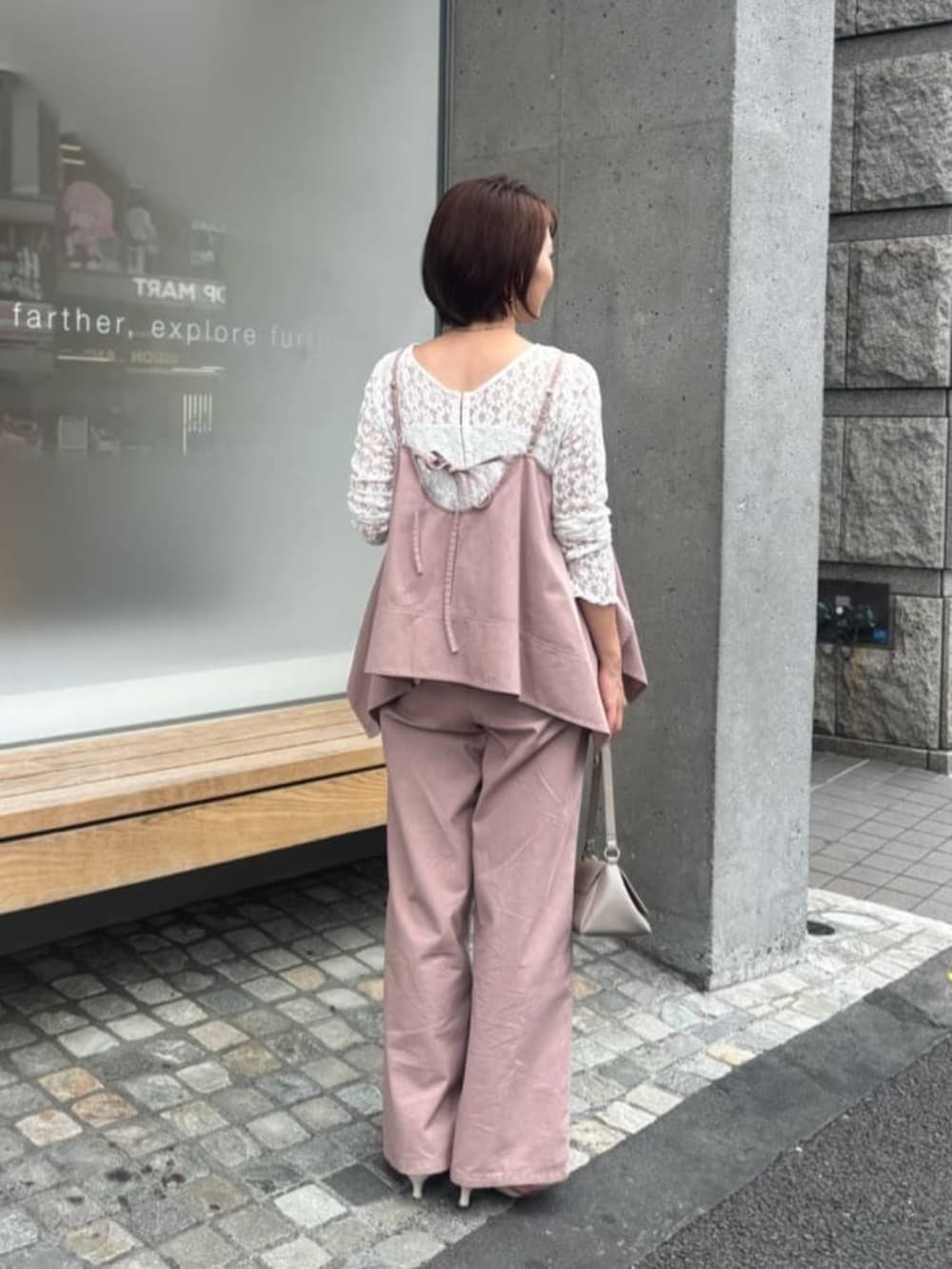 ベージュ系のショルダーバッグ、ホワイト系のTシャツ/カットソー、ピンク系のキャミソールを着用したレディースの夏コーディネートの2枚目の写真