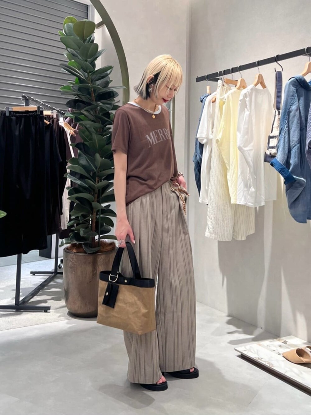 その他のスラックス、ブラウン系のTシャツ/カットソー、ブラック系のサンダルを着用したレディースの夏コーディネートの2枚目の写真