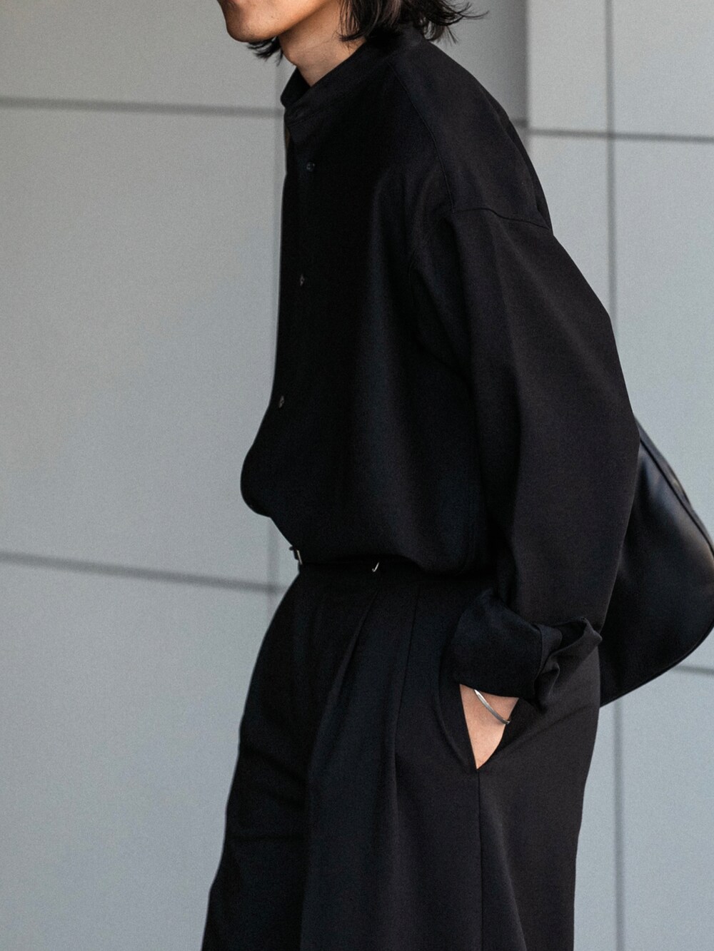 ブラック系のスラックス、ブラック系のシャツ/ブラウス、ブラック系のショルダーバッグを着用したメンズの秋コーディネートの4枚目の写真