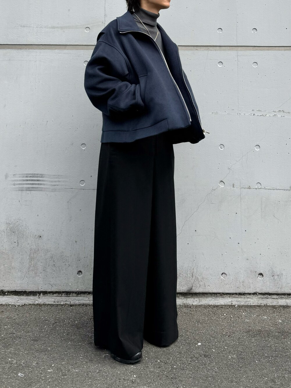 ブルー系のブルゾン、グレー系のトップス、ブラック系のパンツを着用したメンズの秋コーディネートの2枚目の写真