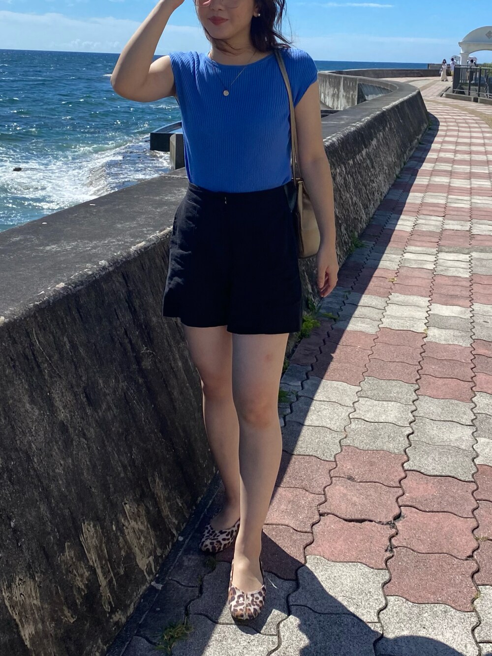 ブラック系のその他パンツ、ブルー系のトップスを着用したレディースの夏コーディネートの2枚目の写真