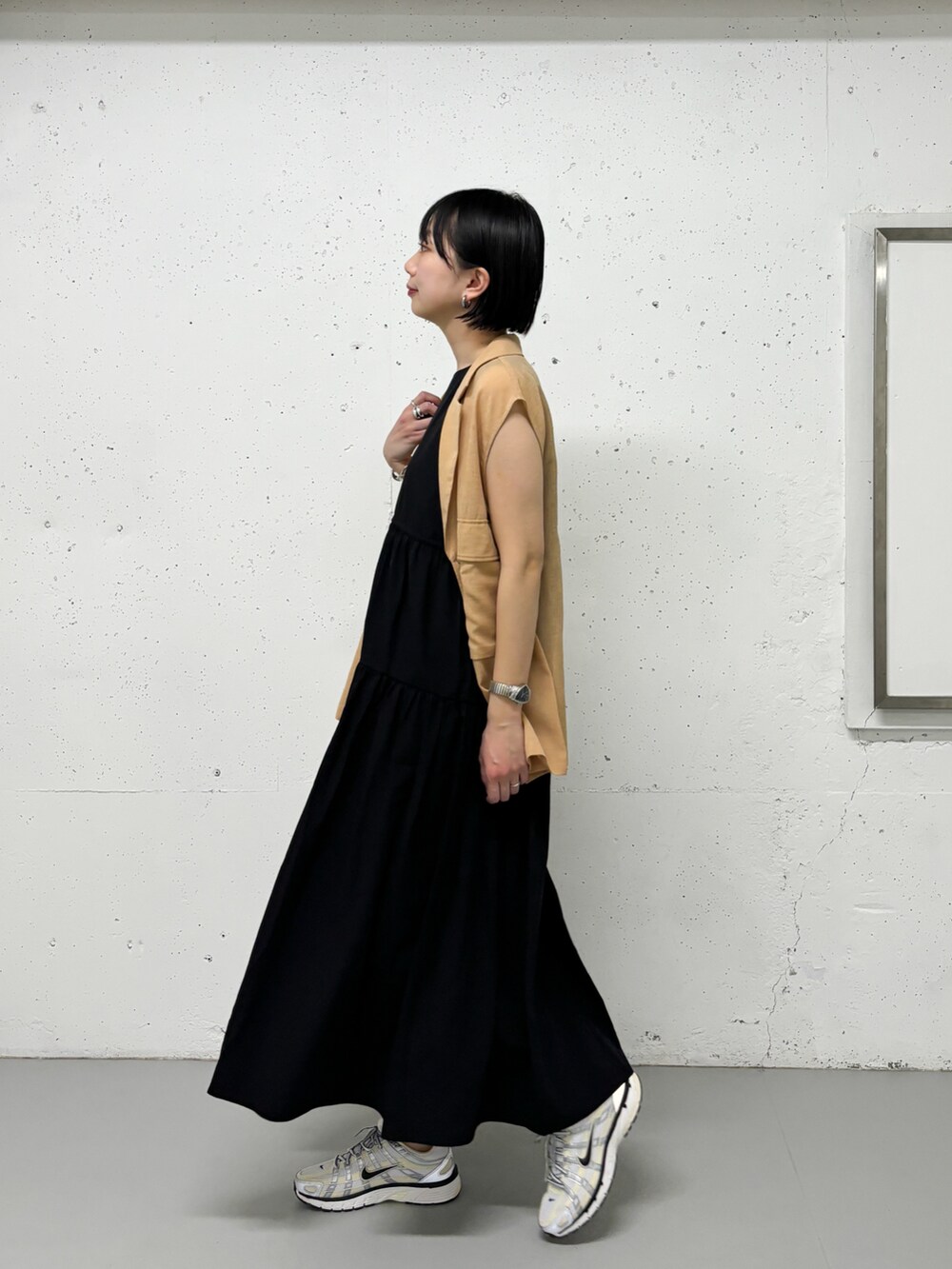 ブラック系のワンピースを着用したレディースの春コーディネートの2枚目の写真