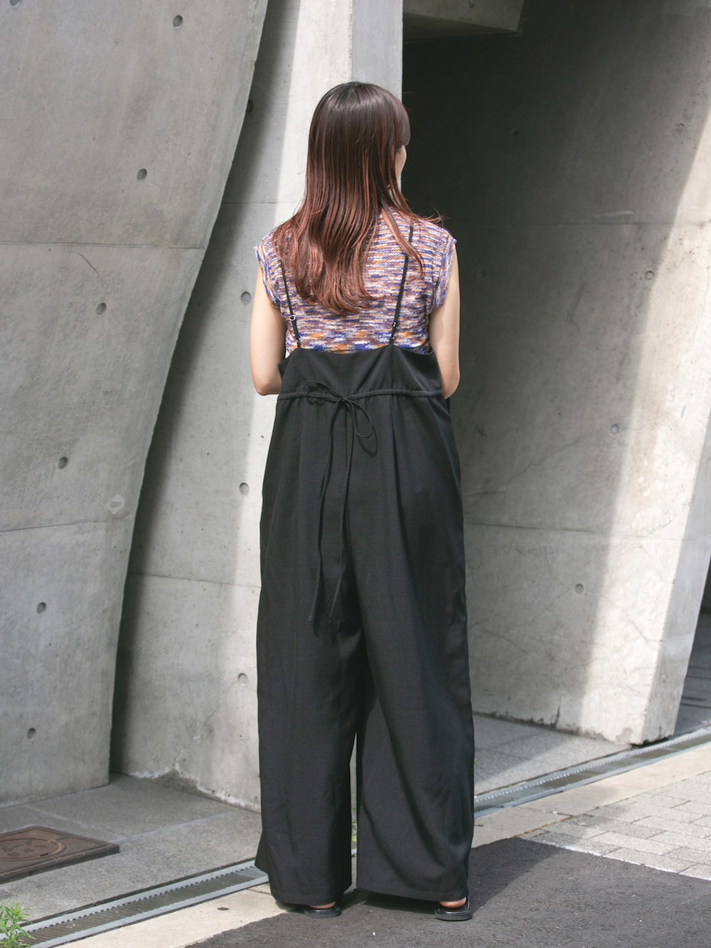 ブルー系のニット/セーター、ブラック系のサロペット/オーバーオール、ブラック系のサンダルを着用したレディースの夏コーディネートの2枚目の写真