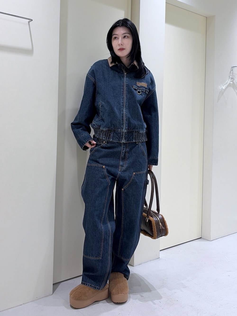 ブルー系のその他アウター、ブルー系のデニムパンツ、ブラウン系のショルダーバッグを着用したレディースの冬コーディネートの4枚目の写真