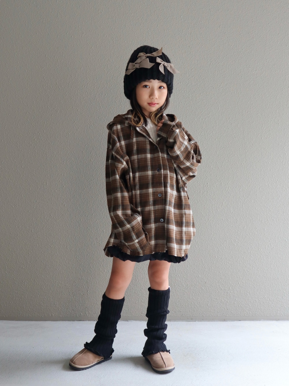 ブラウン系のシャツ/ブラウス、ブラック系のスカート、ベージュ系のブーツを着用したキッズの秋コーディネートの3枚目の写真