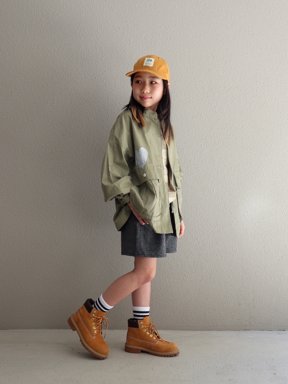 ベージュ系のブーツ、グリーン系のシャツ/ブラウス、ホワイト系のソックス/靴下を着用したキッズの春コーディネートの4枚目の写真