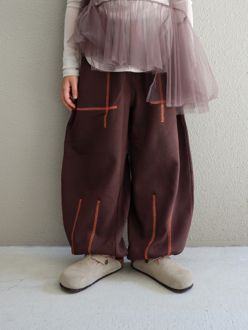 ブラウン系のジャケット/アウター、ブラウン系のパンツ、ベージュ系のサンダルを着用したキッズの秋コーディネートの5枚目の写真