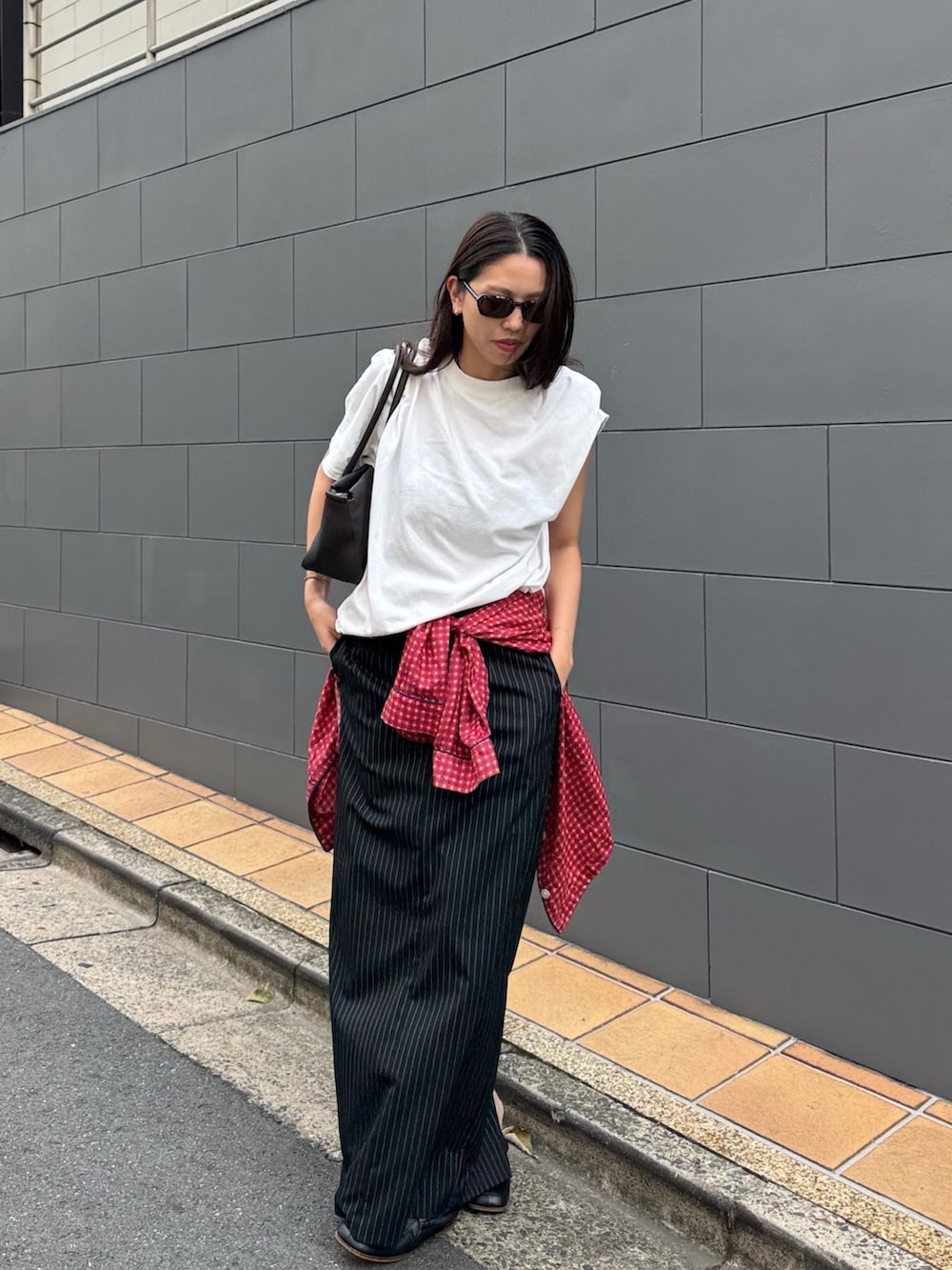 ホワイト系のTシャツ/カットソー、ブラック系のスカート、レッド系のシャツ/ブラウスを着用したレディースの秋コーディネートの2枚目の写真