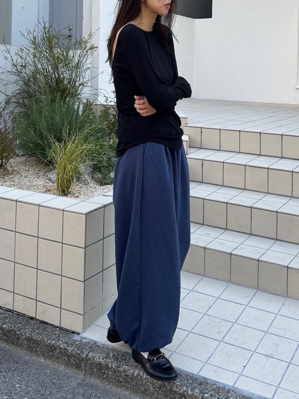 ブラック系のTシャツ/カットソー、ブルー系のスウェットパンツ、ブルー系のバッグを着用したレディースの春コーディネートの2枚目の写真