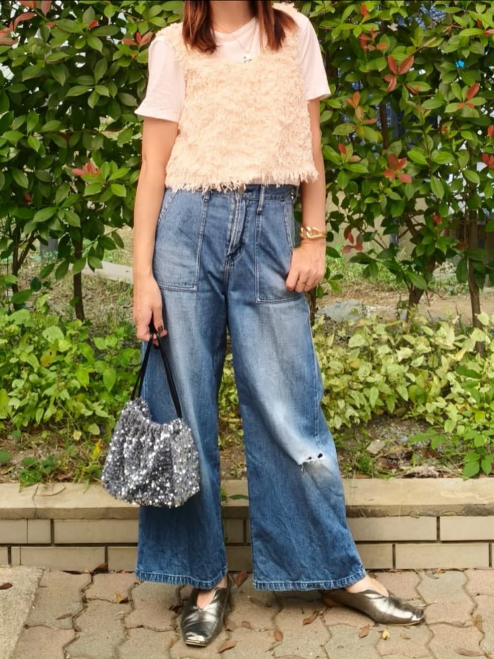 ホワイト系のTシャツ/カットソー、ホワイト系のベスト、ブルー系のデニムパンツを着用したレディースの秋コーディネートの2枚目の写真