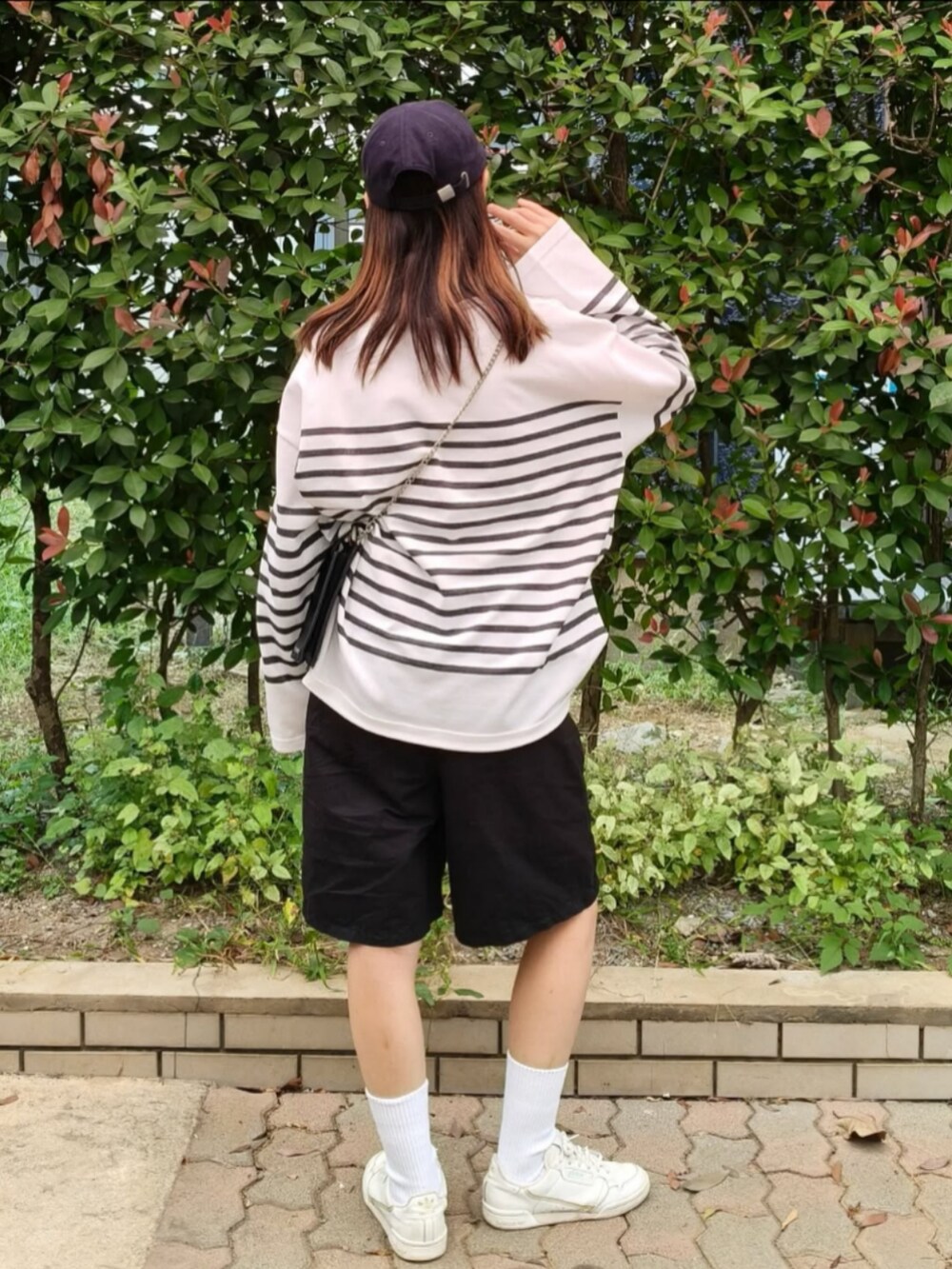 ホワイト系のTシャツ/カットソー、ブラック系のショルダーバッグ、ブラック系のその他パンツを着用したレディースの秋コーディネートの4枚目の写真