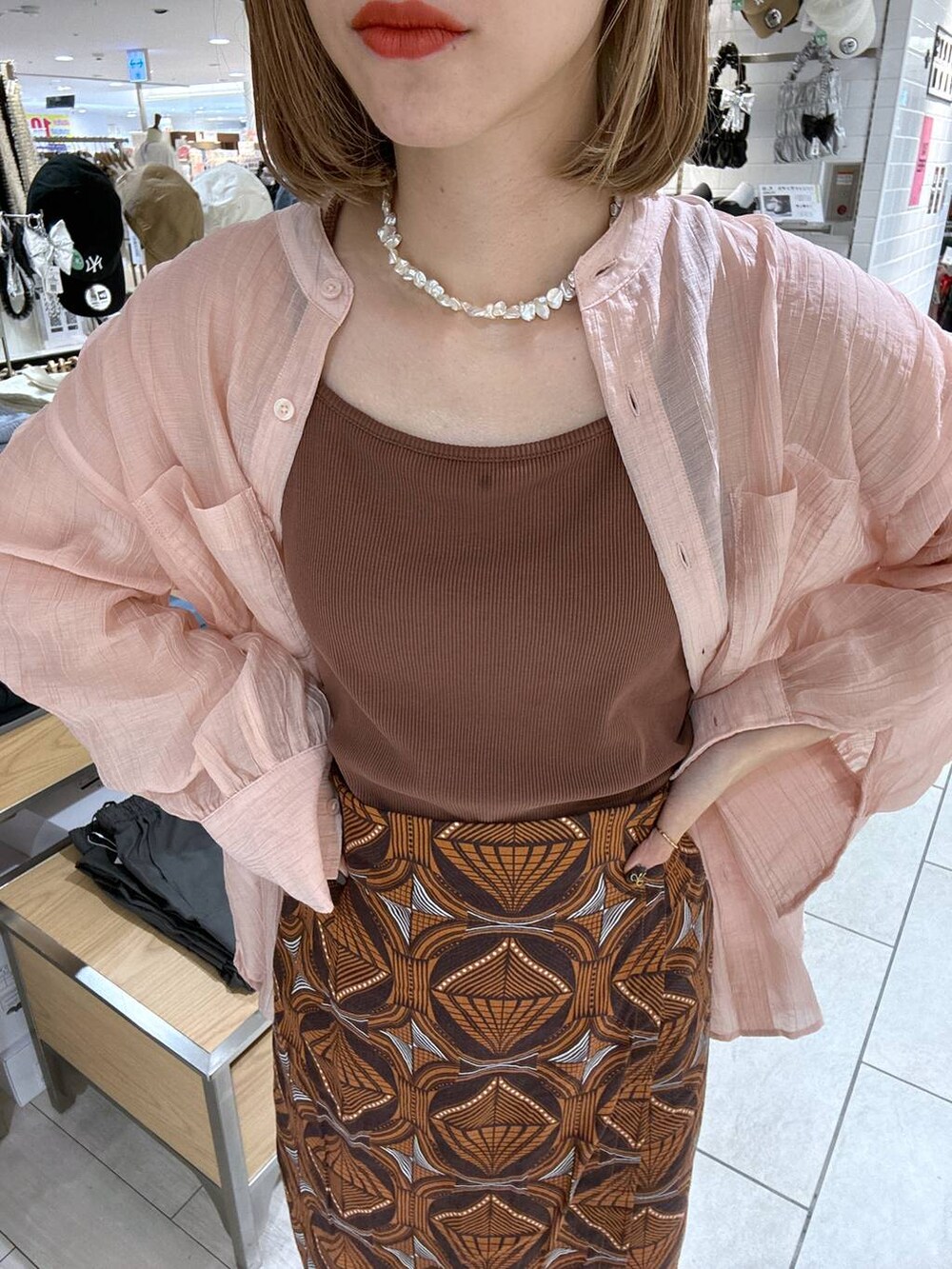 ホワイト系のトートバッグ、ブラウン系のTシャツ/カットソー、ピンク系のシャツ/ブラウスを着用したレディースの夏コーディネートの8枚目の写真