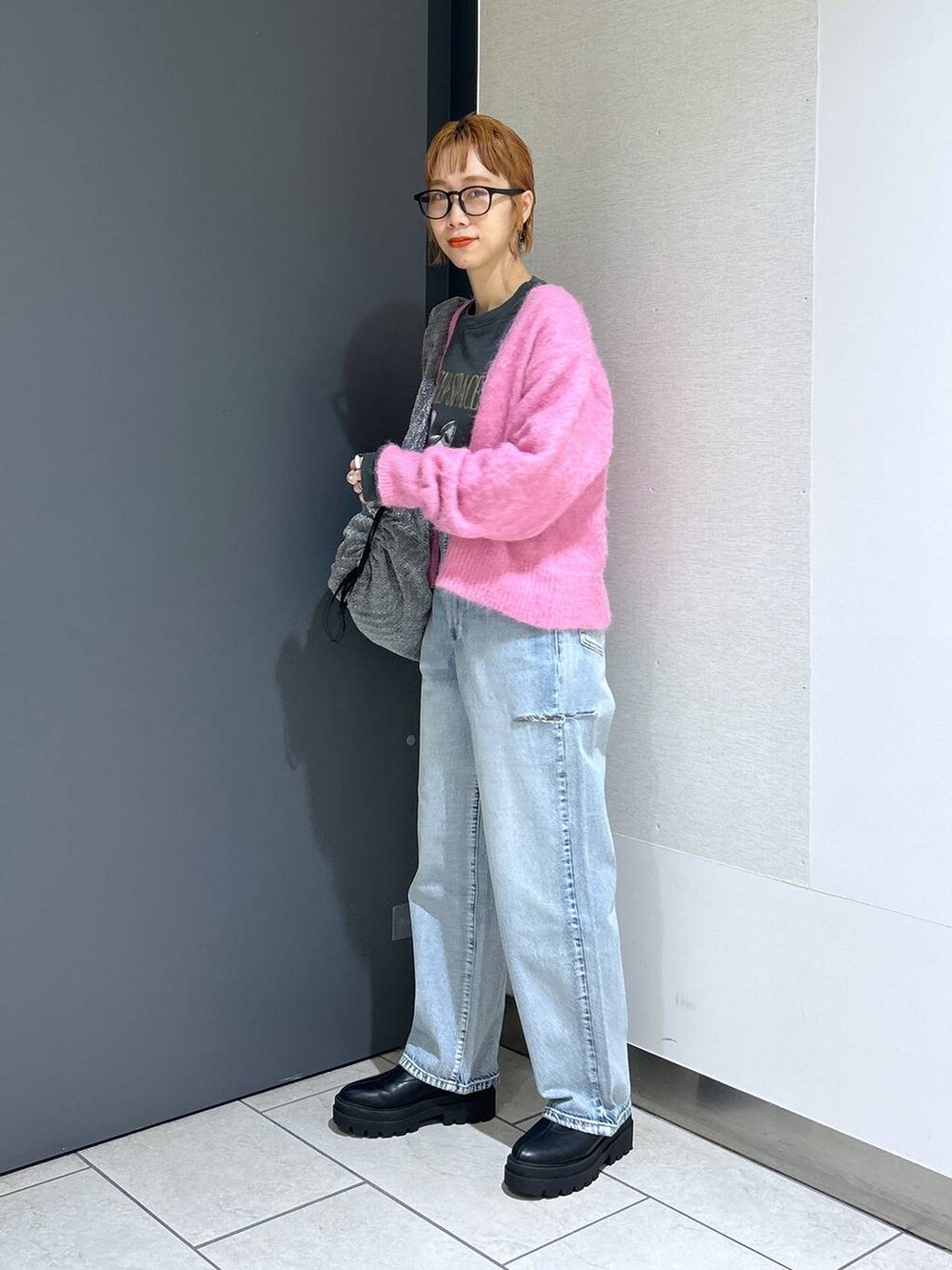 ブルー系のデニムパンツ、シルバー系のショルダーバッグ、ピンク系のカーディガン/ボレロを着用したレディースの冬コーディネートの8枚目の写真