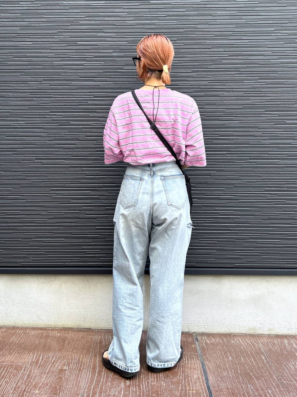 ピンク系のTシャツ/カットソー、ブラック系のショルダーバッグ、ブルー系のデニムパンツを着用したレディースの夏コーディネートの6枚目の写真