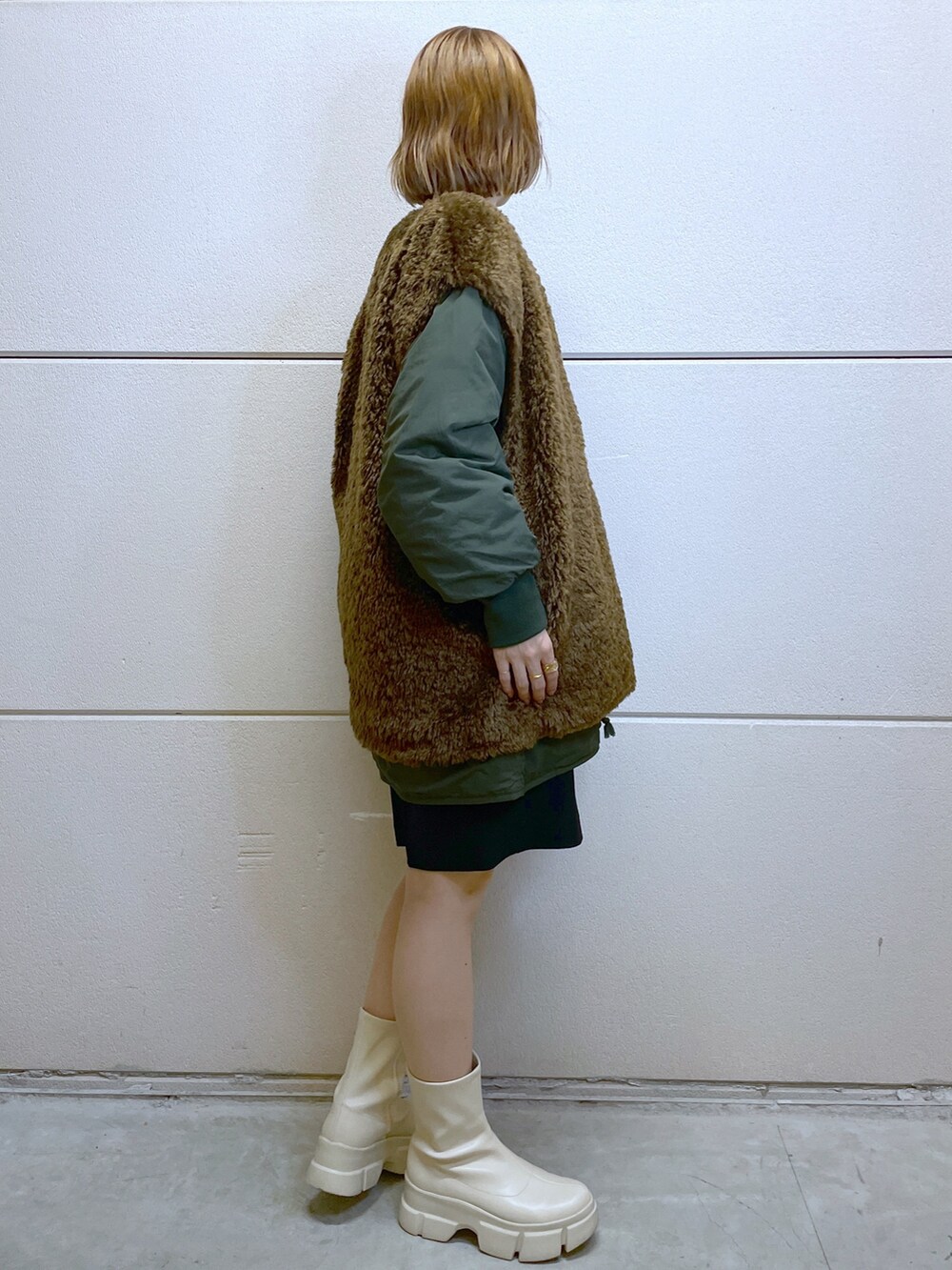 グリーン系のジャケット/アウター、ブラック系のその他パンツ、ホワイト系のブーツを着用したレディースの秋コーディネートの4枚目の写真