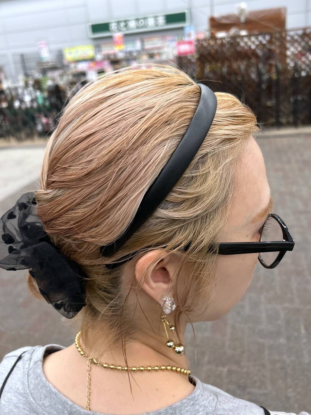 ブラック系のサンダル、ブルー系のデニムパンツ、イエロー系のトートバッグを着用したレディースの春コーディネートの5枚目の写真