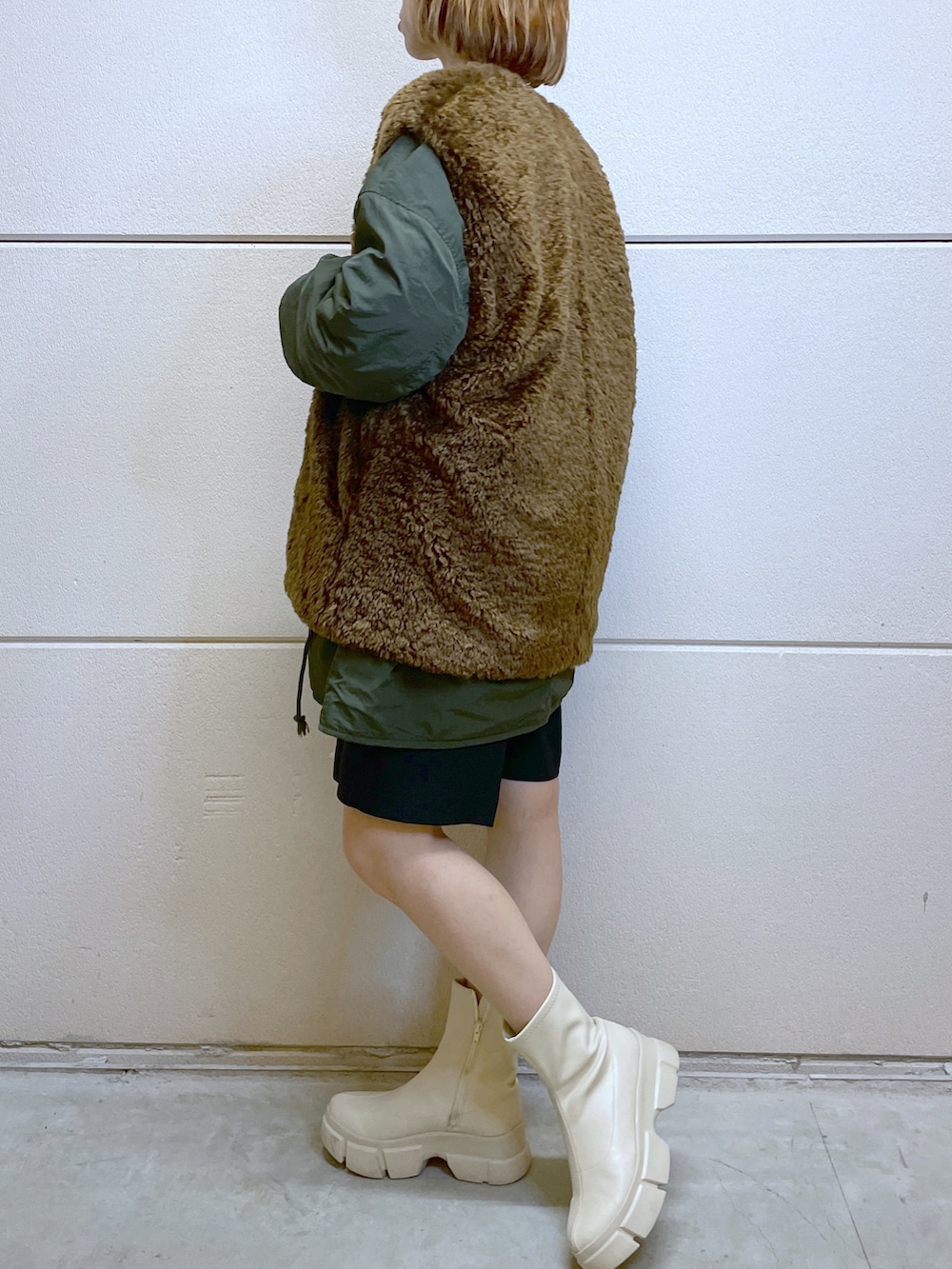 グリーン系のジャケット/アウター、ブラック系のその他パンツ、ホワイト系のブーツを着用したレディースの秋コーディネートの2枚目の写真