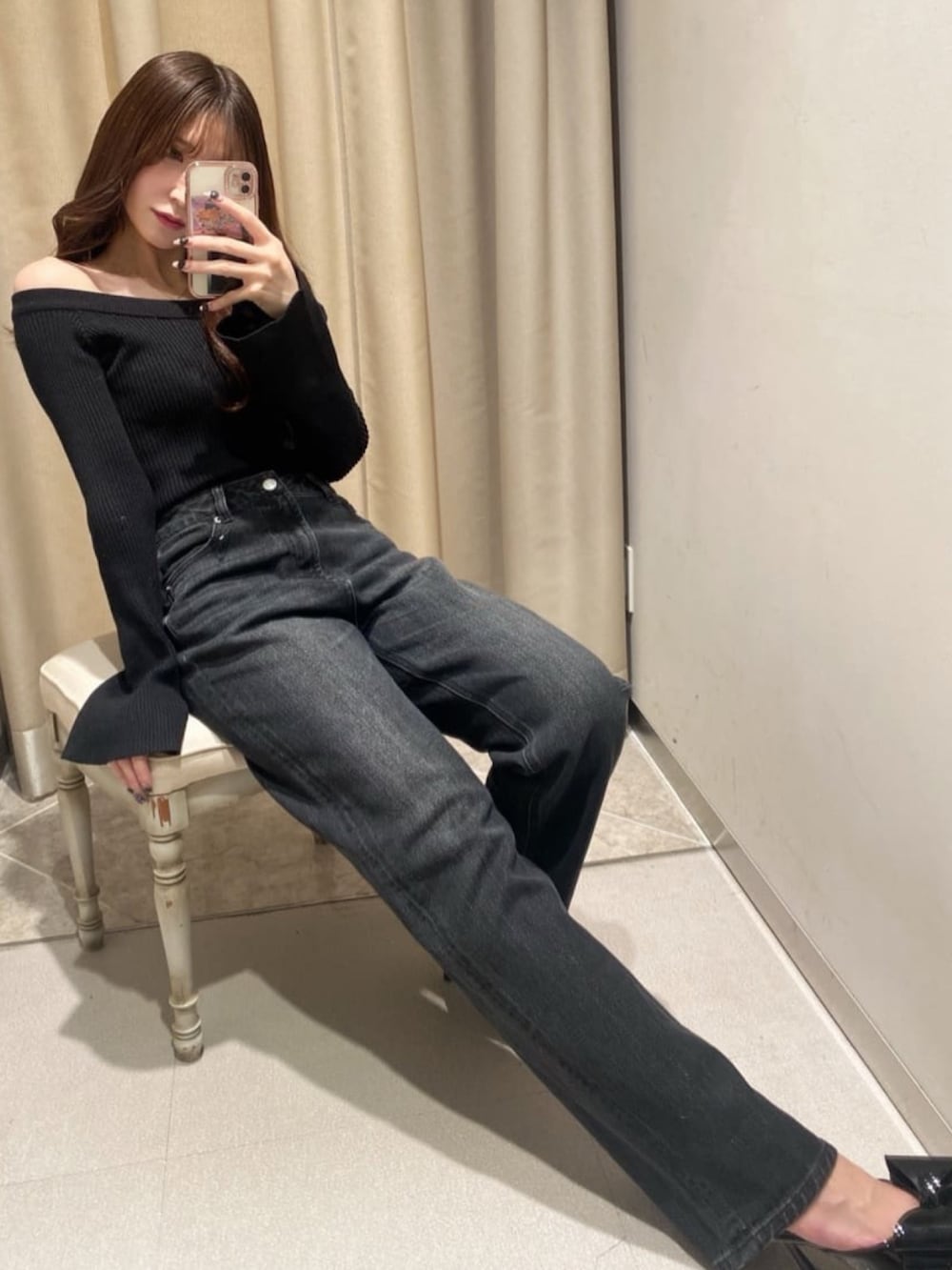 ブラック系のニット/セーター、ブラック系のデニムパンツ、ブラック系のパンプスを着用したレディースの冬コーディネートの2枚目の写真