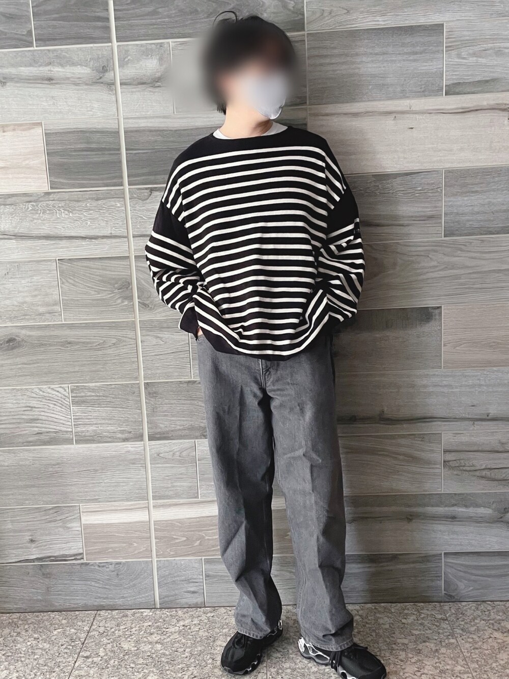 ブラック系のTシャツ/カットソー、グレー系のデニムパンツ、ブラック系のスニーカーを着用したメンズの秋コーディネートの4枚目の写真