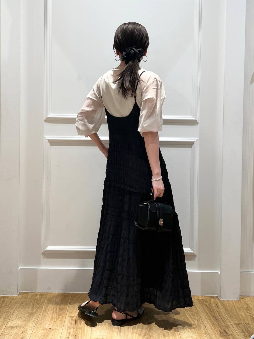 ブラック系のワンピース、ベージュ系のシャツ/ブラウス、ブラック系のパンプスを着用したレディースの春コーディネートの3枚目の写真