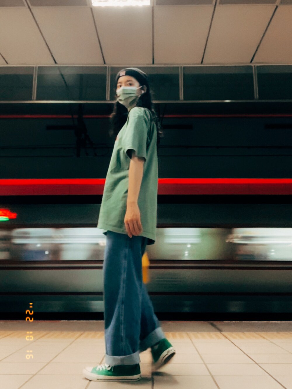 ブルー系のデニムパンツ、グリーン系のスニーカー、ブラック系のニットキャップ/ビーニーを着用したレディースの秋コーディネートの2枚目の写真